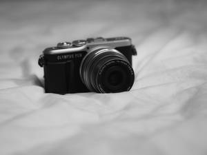 Black Nikon Dslr Camera On White Textile Wallpaper