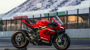 Blazing Down The Highway On A Bright Blue Motorcycle Wallpaper