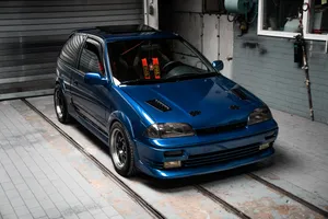 Blue Bmw M 3 Coupe Parked Beside White Building Wallpaper