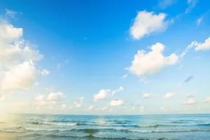 Blue Gradient Horizon With Cottony Clouds Wallpaper