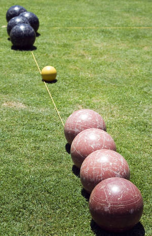 Bocce Ball Black And Brown On Grass Wallpaper