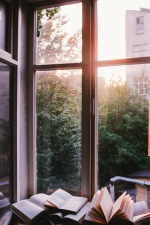 Books Beside Window During Sunset Wallpaper