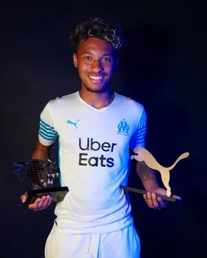 Boubacar Kamara Holding Two Trophies Wallpaper