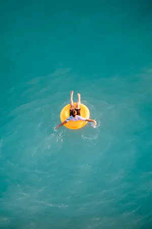 Boy Sitting On Buoy Wallpaper