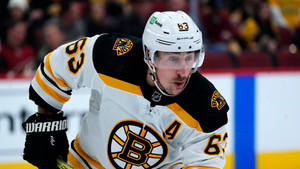 Brad Marchand Of The Boston Bruins In Action With White Uniform. Wallpaper