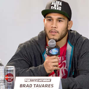 Brad Tavares Holding A Microphone Wallpaper