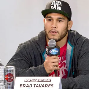 Brad Tavares Holding A Microphone Wallpaper