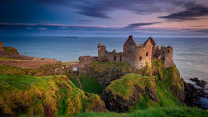 Breathtaking View Of Dunluce Castle In Ireland Wallpaper