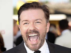 British Comedian And Actor Ricky Gervais Strikes A Pose Wallpaper