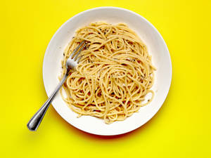 Cacio E Pepe On Yellow Surface Wallpaper