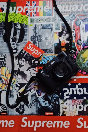 Camera On Superior Supreme Logo Collage Wallpaper