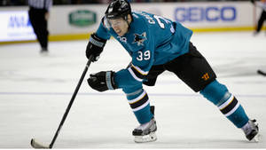 Canadian Professional Ice Hockey Center Logan Couture Playing On Rink Wallpaper