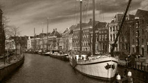 Canal With Boats And Houses Wallpaper