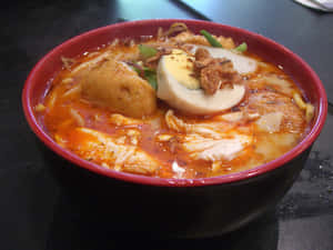 Caption: A Bowl Of Authentic Singaporean Coconut Curry Laksa Wallpaper