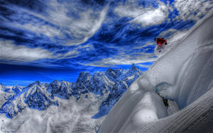 Caption: A Breathtaking View Of Snow Mountain Skiing Wallpaper