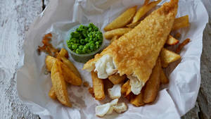 Caption: A Delightful Feast Of Half-eaten Fish And Chips Wallpaper