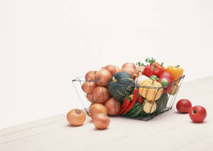 Caption: An Enlivened Basket Of Fresh Vegetables Wallpaper