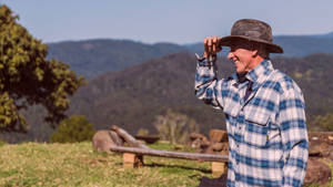 Caption: Cheerful Farmer Enjoying His Work Wallpaper