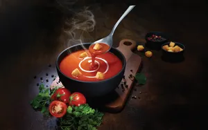 Caption: Classic Tomato Soup Garnished With Croutons Wallpaper