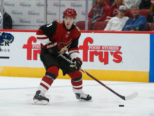 Caption: Clayton Keller In Action Against Vancouver Canucks Wallpaper