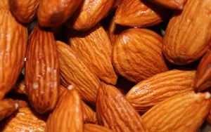 Caption: Close-up Shot Of Almond Nuts Wallpaper