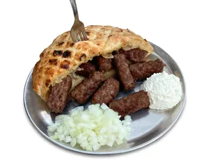 Caption: Delicious Cevapi Sausages With Fresh White Sauce Wallpaper
