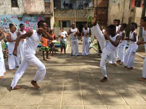 Caption: Dynamic Capoeira Street Sparring Dancing To Rhythm Wallpaper