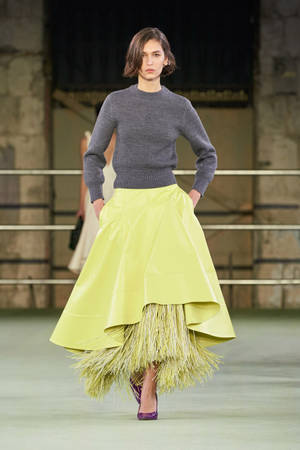 Caption: Elegance In Fashion - Model Wearing Yellow Bottega Veneta Skirt Wallpaper