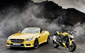 Caption: Elegance In Motion: Yellow Convertible Luxury Car Wallpaper