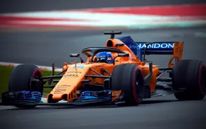 Caption: Fernando Alonso Racing In Orange Mclaren Wallpaper