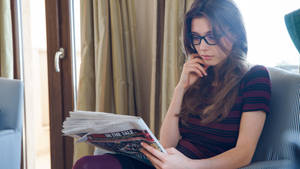 Caption: Intellectual Woman Reading A Book Wallpaper