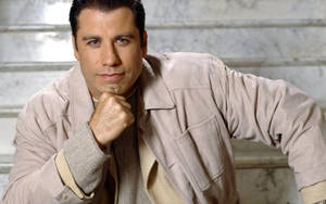 Caption: John Travolta: Iconic American Actor In Creative Pose Wallpaper