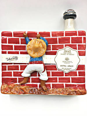 Caption: Luxurious Bottle Of Adictivo Border Wall Extra Anejo Tequila Wallpaper