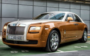 Caption: Luxury Refined - The Elegant Rolls-royce Ghost. Wallpaper