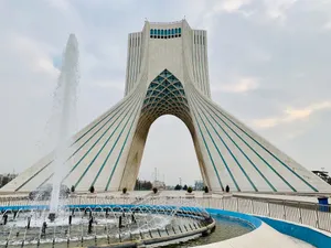 Caption: Magnificent View Of Azadi Tower With Fountain At Twilight Wallpaper