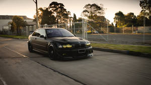 Caption: Majestic Black Bmw Under Twilight Sky Wallpaper