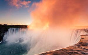 Caption: Mystical Niagara Falls Shrouded In Heavenly Pink Mist Wallpaper