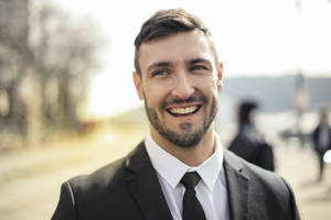 Caption: Professional Man In Suit Headshot Wallpaper