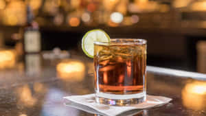 Caption: Savoring Elegance: Whiskey Cocktail With Lime Wallpaper