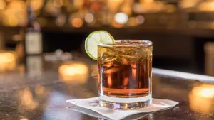 Caption: Savoring Elegance: Whiskey Cocktail With Lime Wallpaper