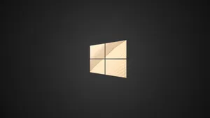 Caption: Shimmering Golden Windows Logo On A Dark Background Wallpaper