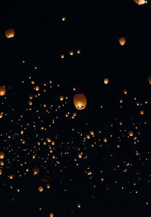 Caption: Sky Lanterns Reflected In Night Sky As Seen On Ipad 2021 Wallpaper