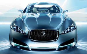 Caption: Sleek Metallic Blueish Silver Jaguar Car Wallpaper