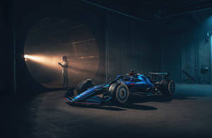 Caption: Stunning Blue Williams Racing Car In Action Wallpaper