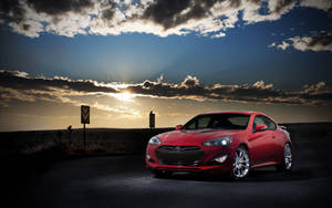 Caption: Stunning Red Genesis Car In An Outdoor Setting Wallpaper
