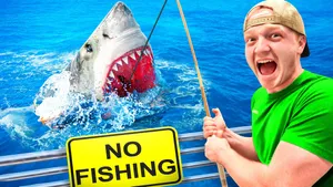 Caption: Unspeakable Youtuber Adventurously Fishing For A Shark Wallpaper