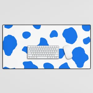 Caption: Vibrant Blue Cow Print On Desk Mat And Keyboard Wallpaper