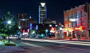 Caption: Vibrant Night View Of Automobile Alley In Oklahoma City. Wallpaper