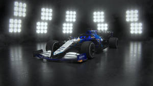 Caption: Williams Racing Car Illuminated By Spotlights Wallpaper