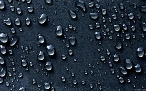 Captivating Close-up Of Dark Water Droplets Wallpaper